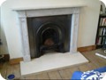Fireplace renovation: after surround and mantlepiece installation and painting. The finish on the wrought iron and surround was achieved with black graphite paste, with blackboard paint used as a primer on the wooden surround. 